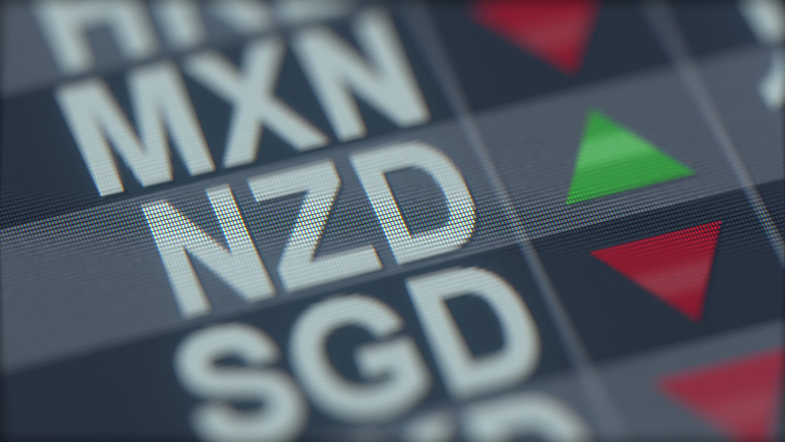 Close-up of a stock market board with a green up-triangle and red down-triangle indicators, blurred text in the background.
